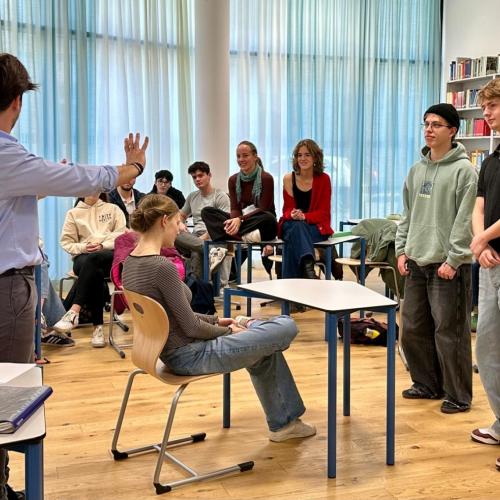Schüler in der Bibliothek, sitzend und stehend